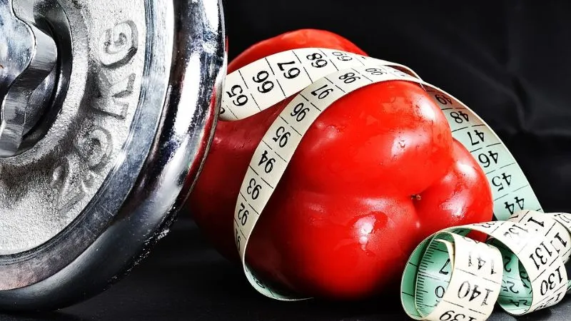 Healthy ingredients like chicken, vegetables, and quinoa prepared in meal prep containers for weight loss.