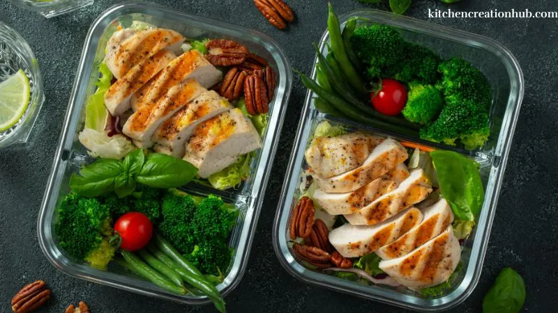 Person preparing healthy meals by chopping vegetables and organizing ingredients.